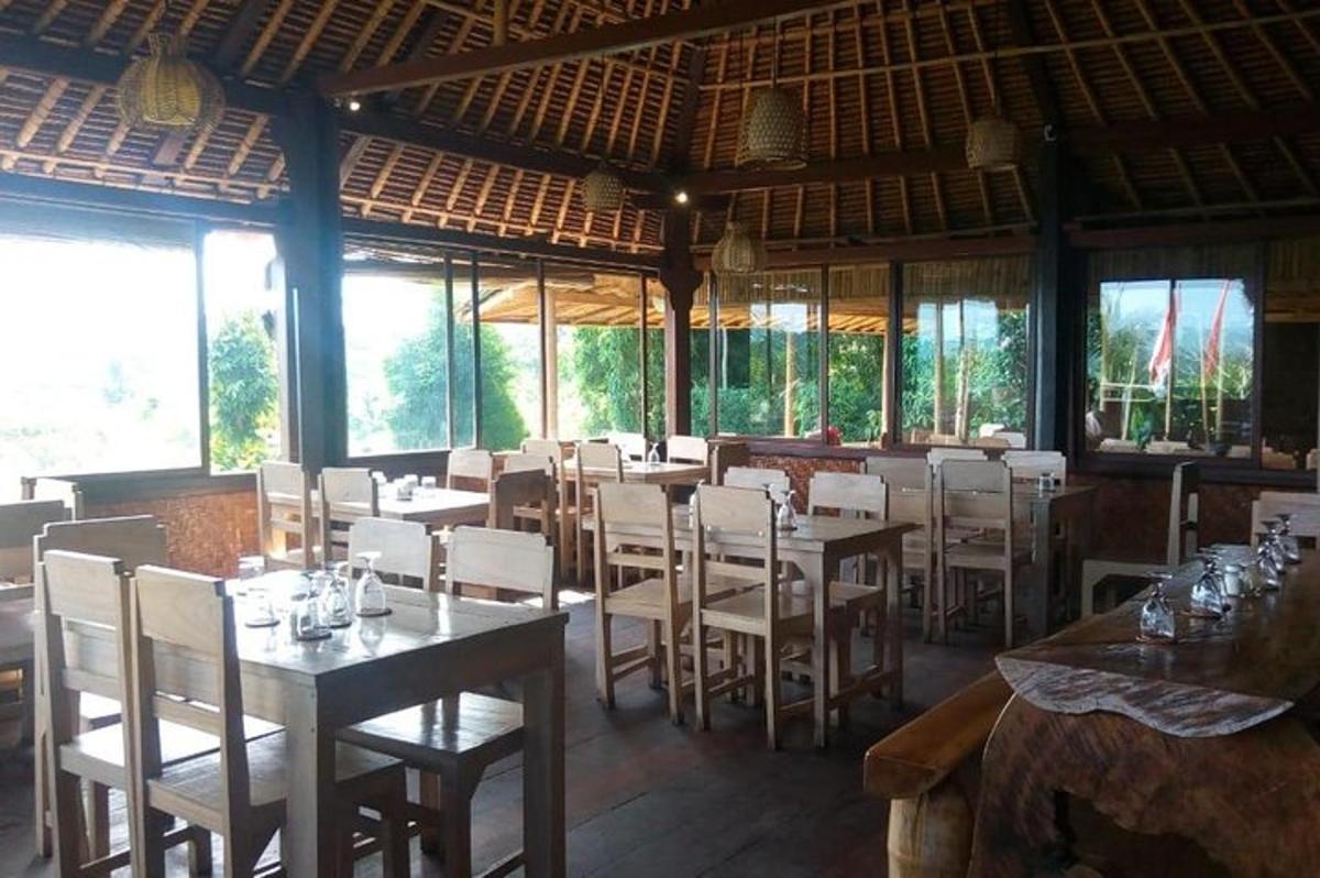 a restaurant with tables and white chairs and windows
