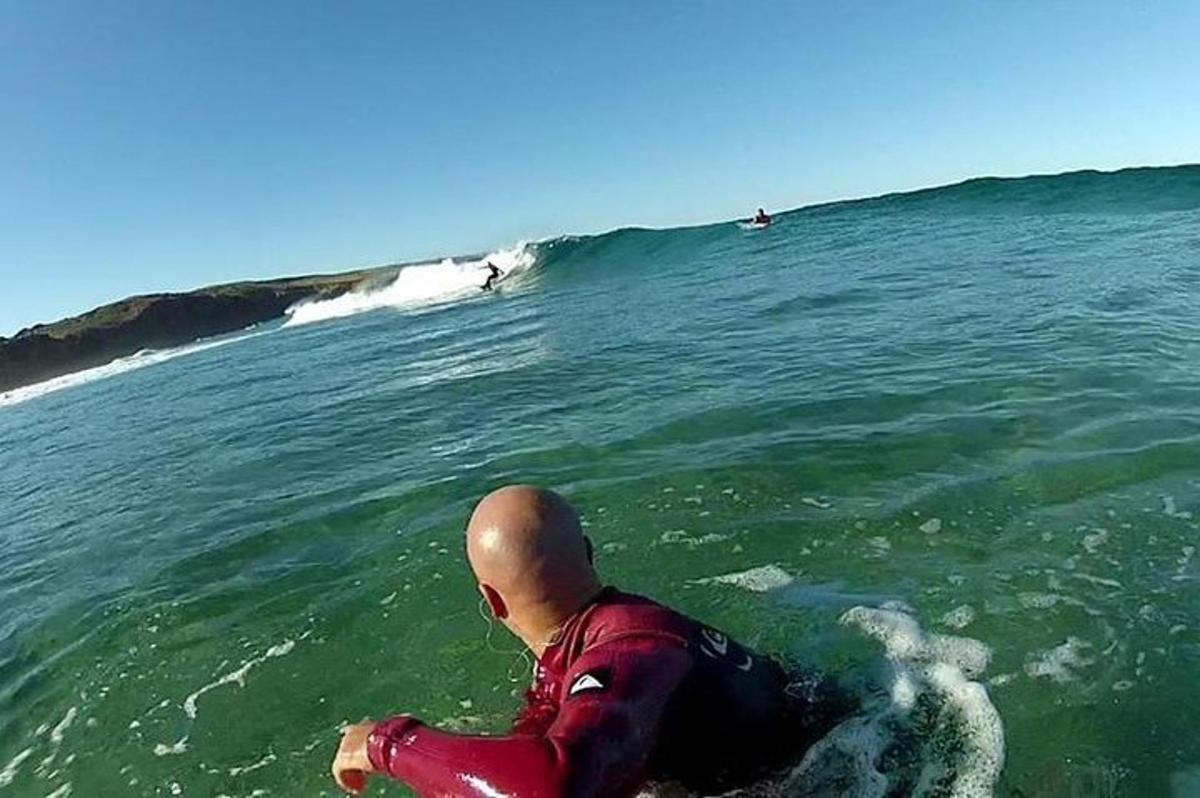 a man riding a wave on a surfboard in the ocean
