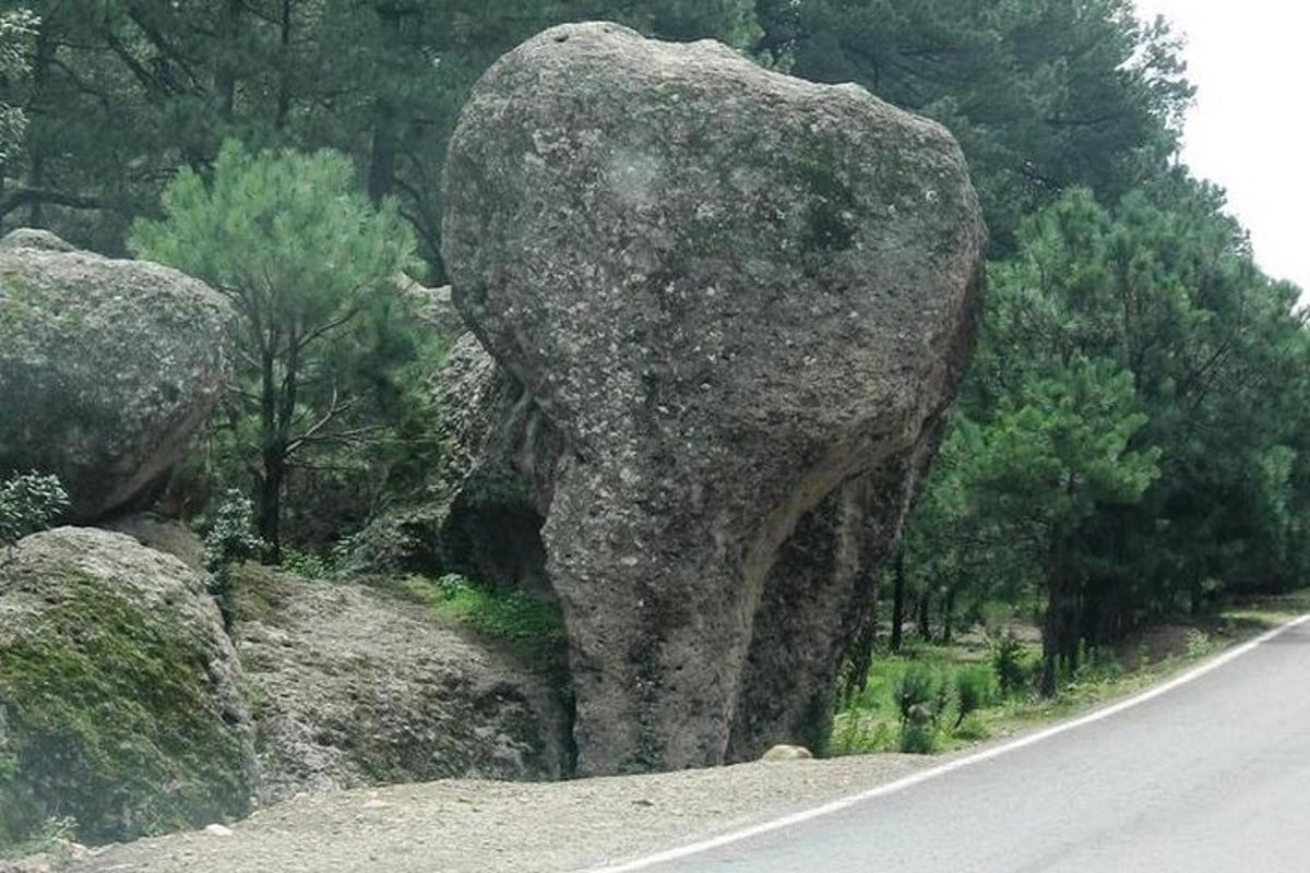 a large rock on the side of a road