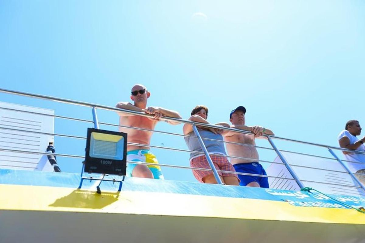 a group of men standing on the side of a boat