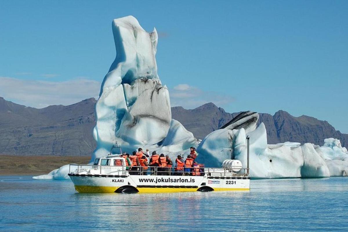 a group of people on a boat in front of an iceberg