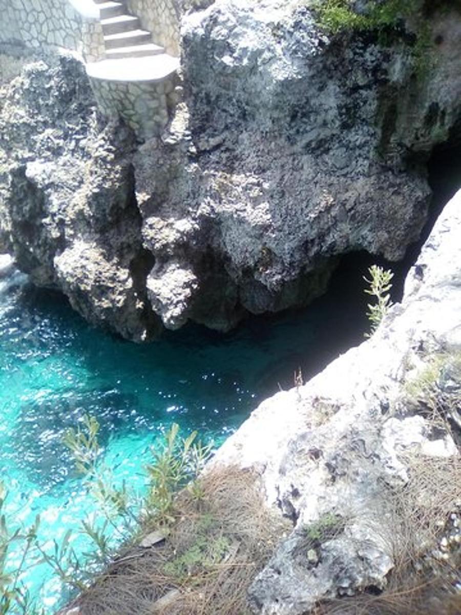 a large rock next to a body of water