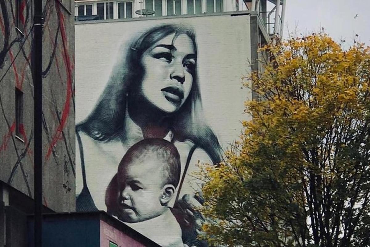a large mural of a woman on the side of a building