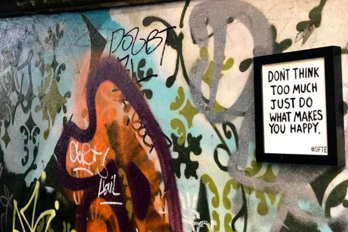 a wall with a painting on it with a sign on it