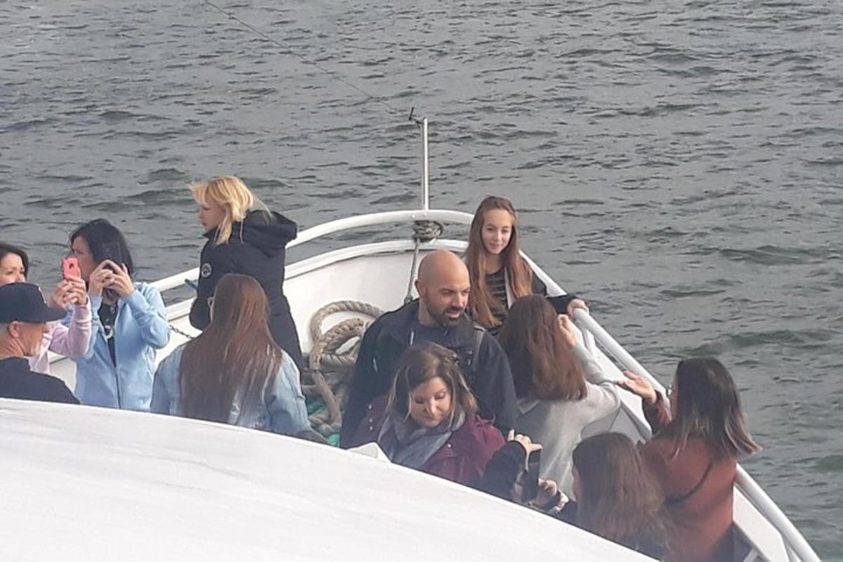 a group of people on a boat in the water