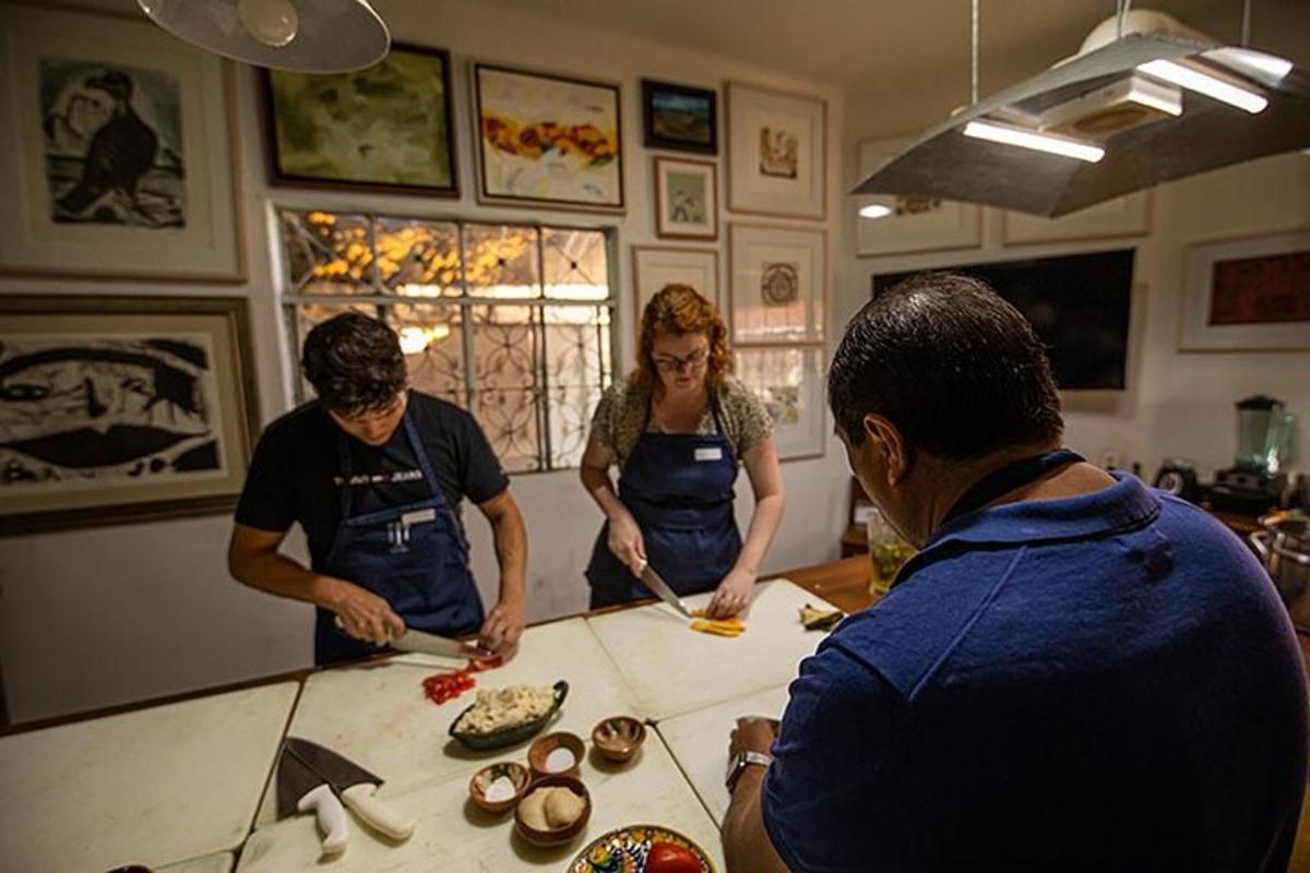 a group of people standing around a counter preparing food