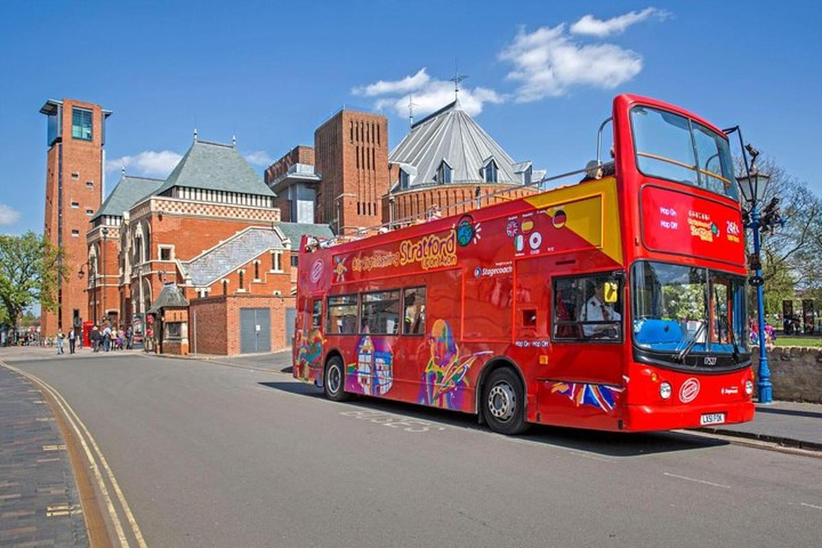 a red double decker bus driving down a street