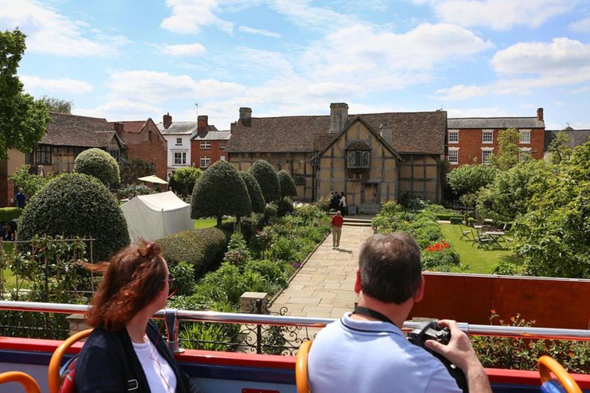a man and a woman taking a picture of a house