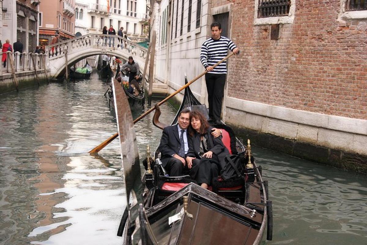 a group of people on a gondola in a canal