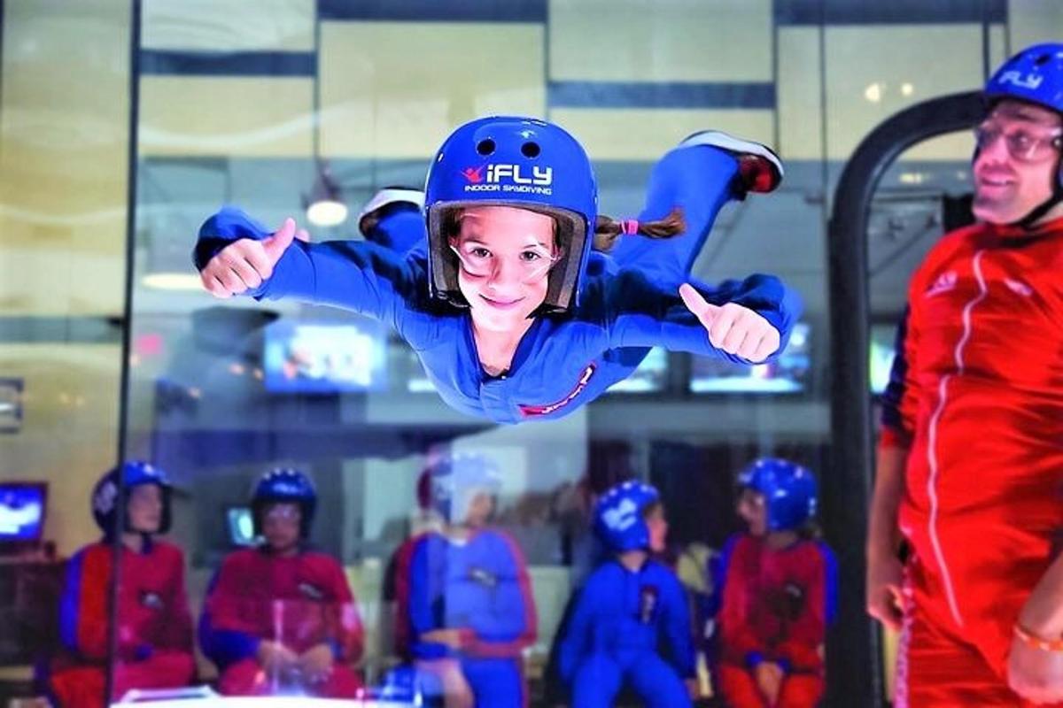 a young girl is doing a trick in the air