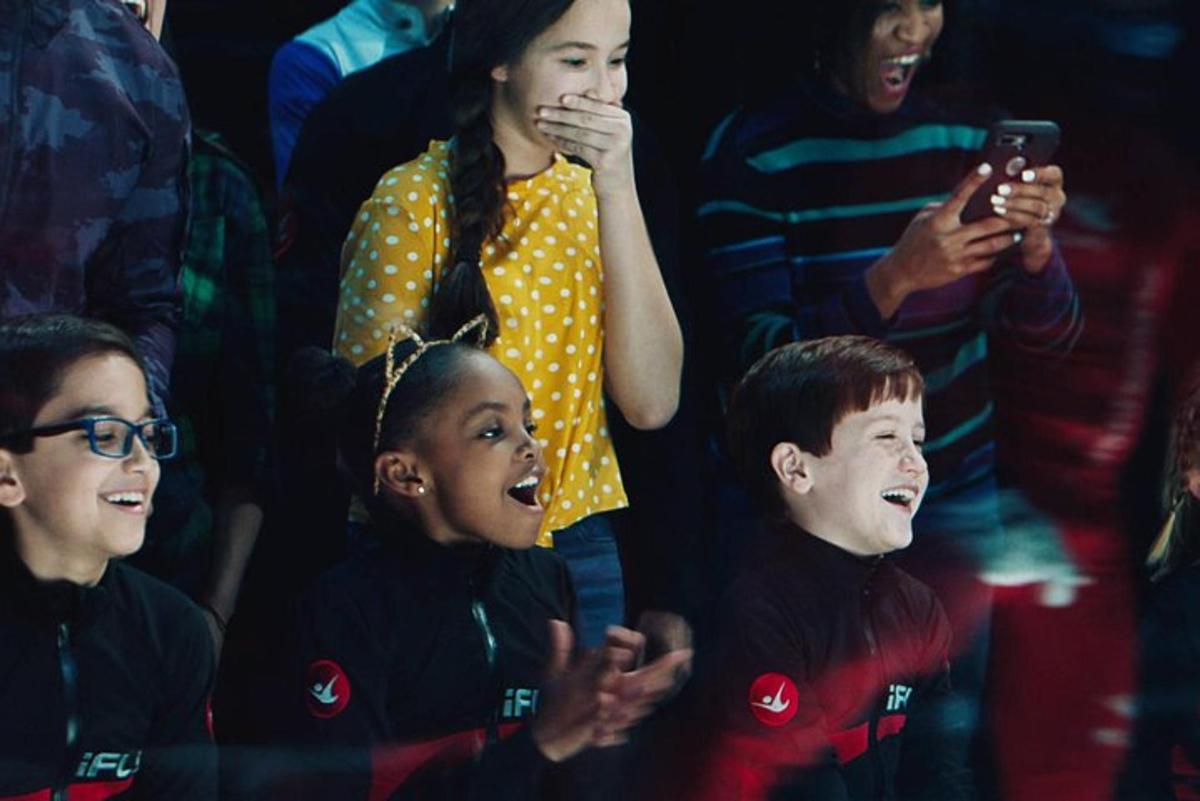 a group of children in a crowd watching a movie