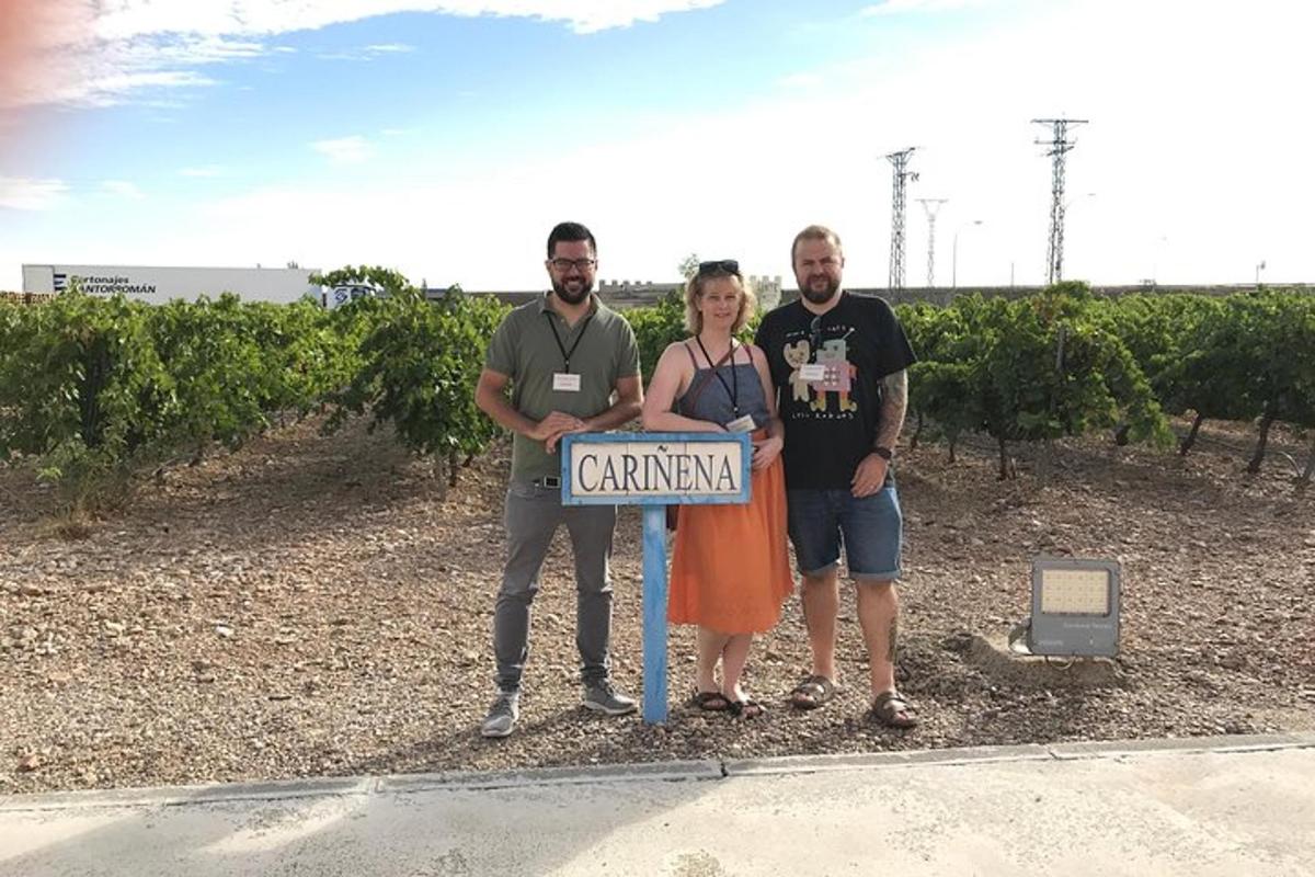 a group of three people standing next to a street sign