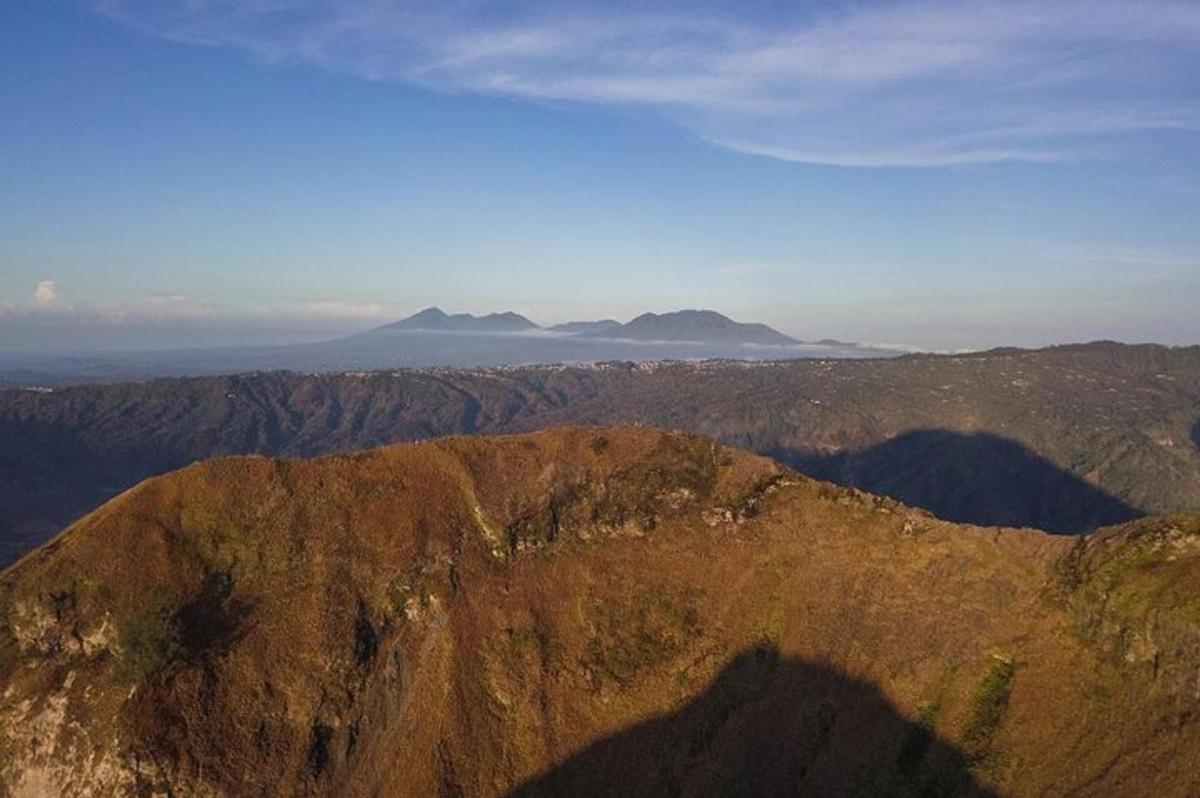 a view of a mountain with mountains in the background