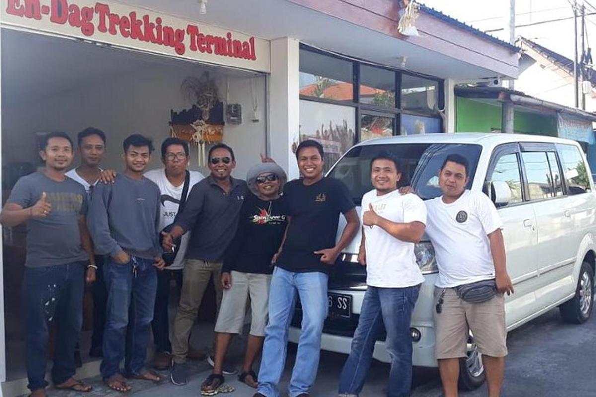 a group of men standing in front of a van