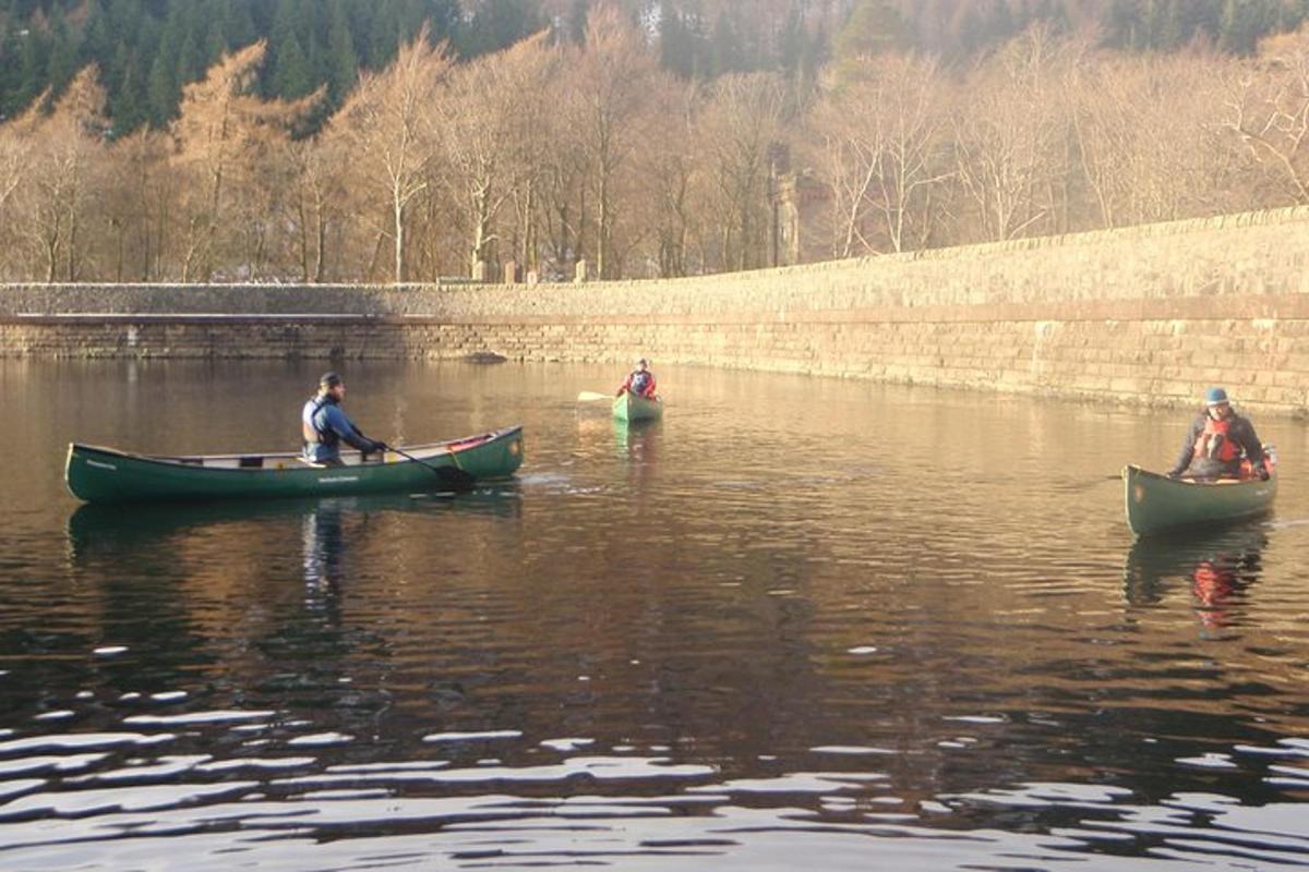 three people in canoes in the water on a river