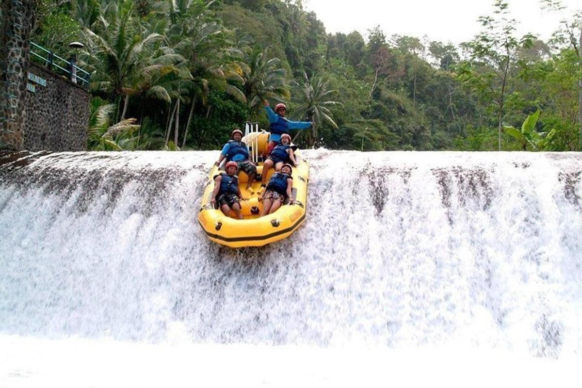 a group of people riding a raft on a waterfall