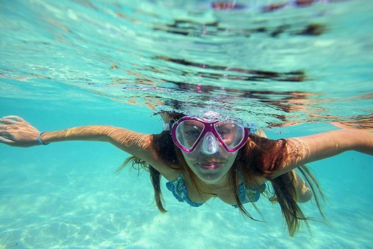 a woman in the water wearing a mask and goggles