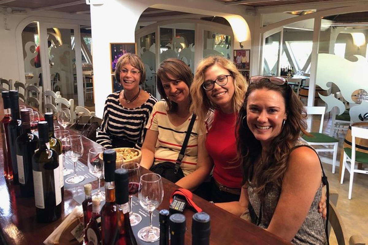 a group of women sitting at a table with wine glasses