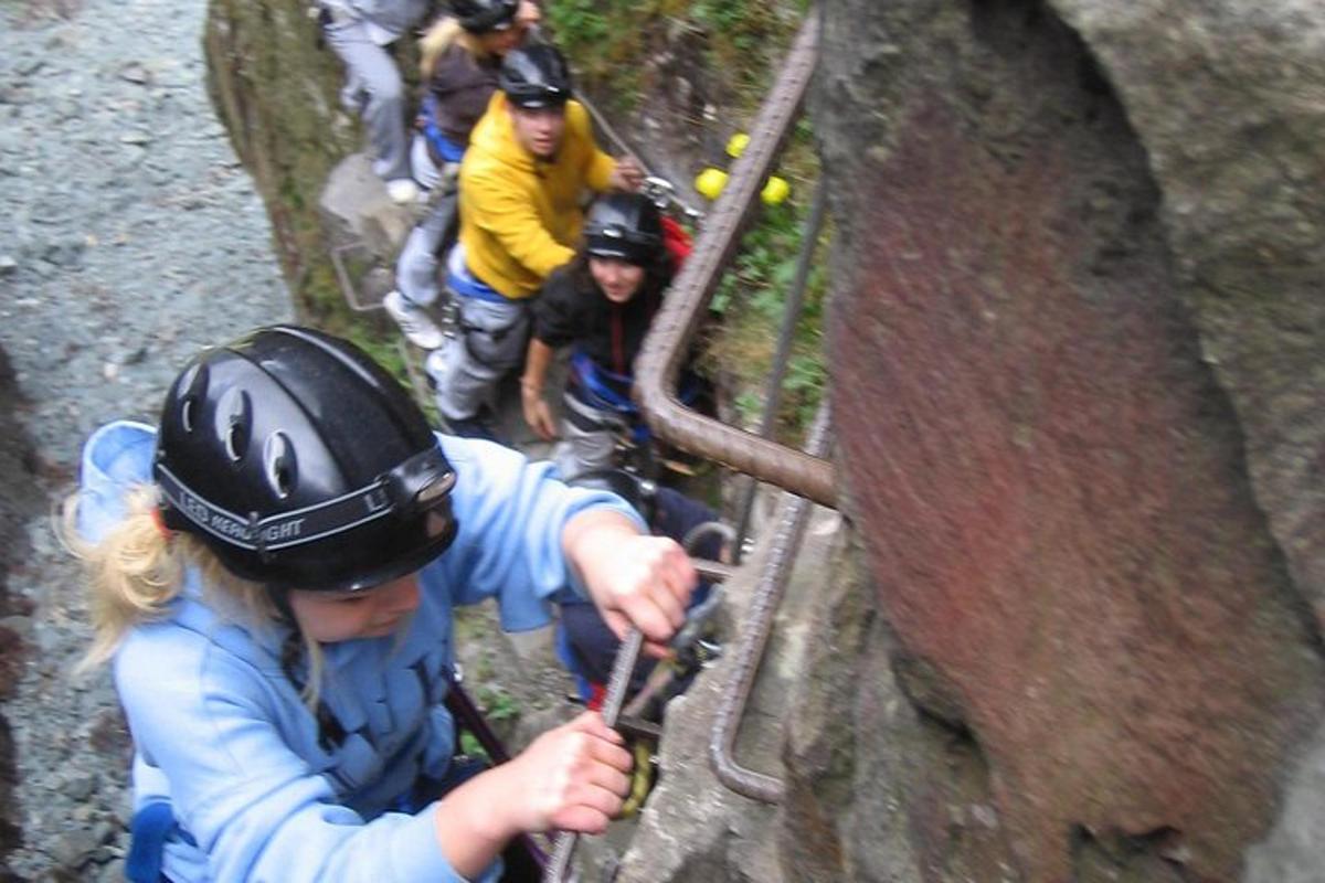 a group of people climbing a rock wall