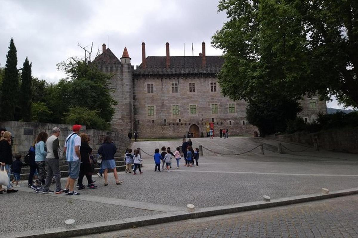 un gruppo di persone in piedi davanti a un castello