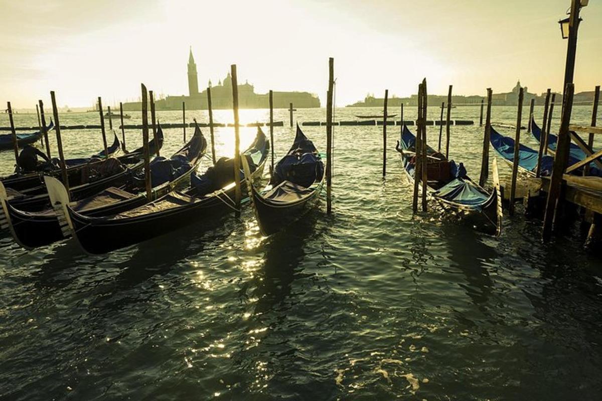 a group of gondolas in the water near a dock