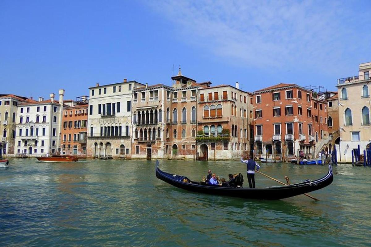 a group of people in a gondola on a canal