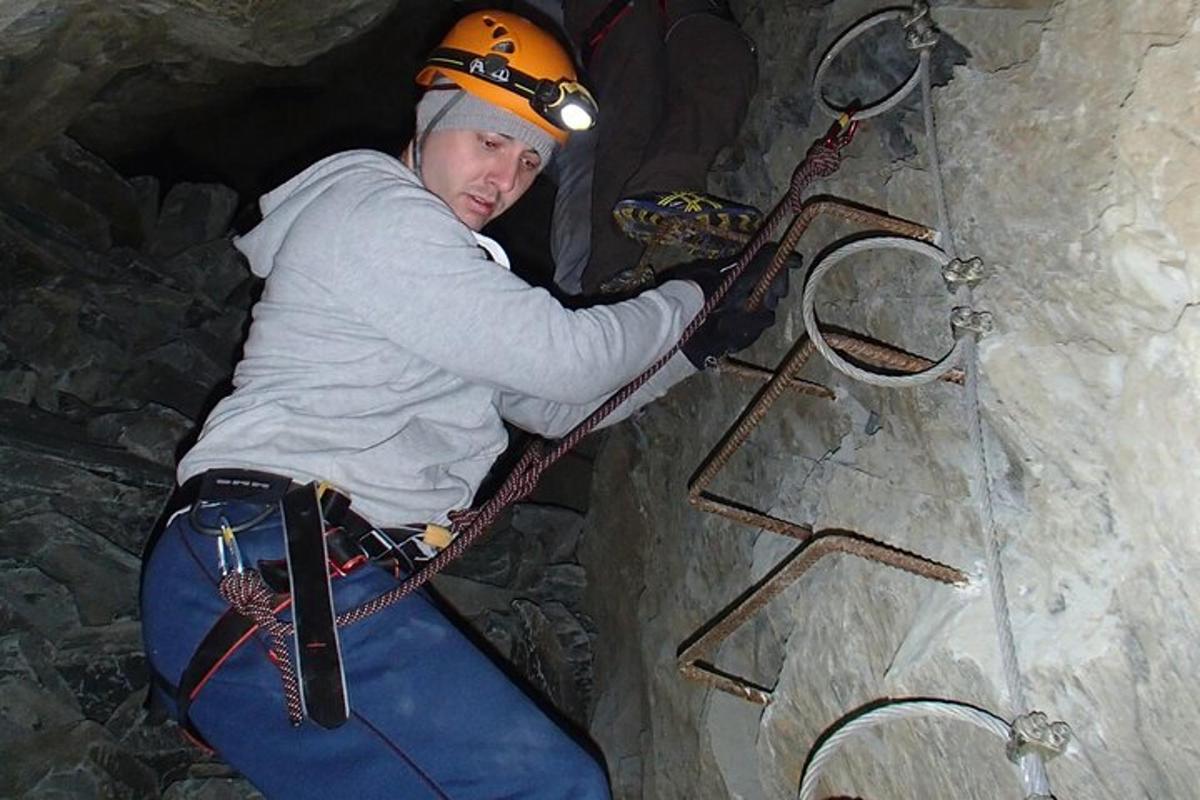 a man is climbing a ladder in a cave