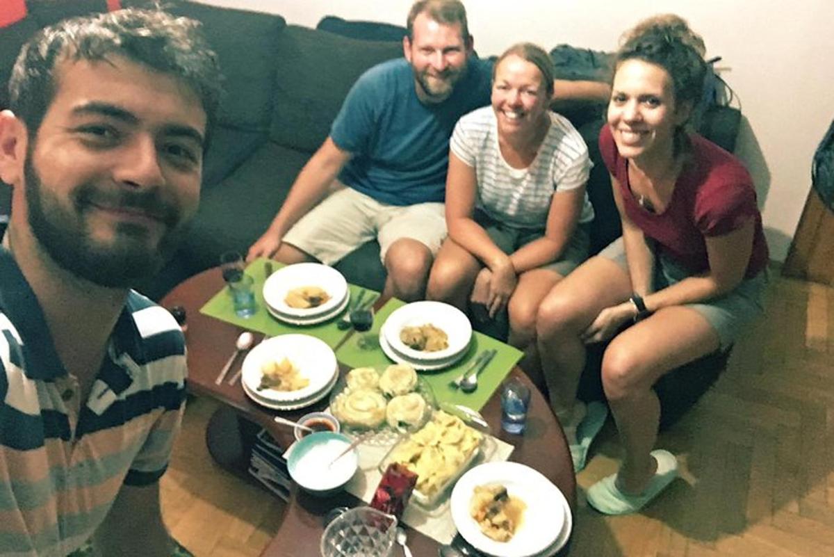 a group of people sitting on a couch eating food