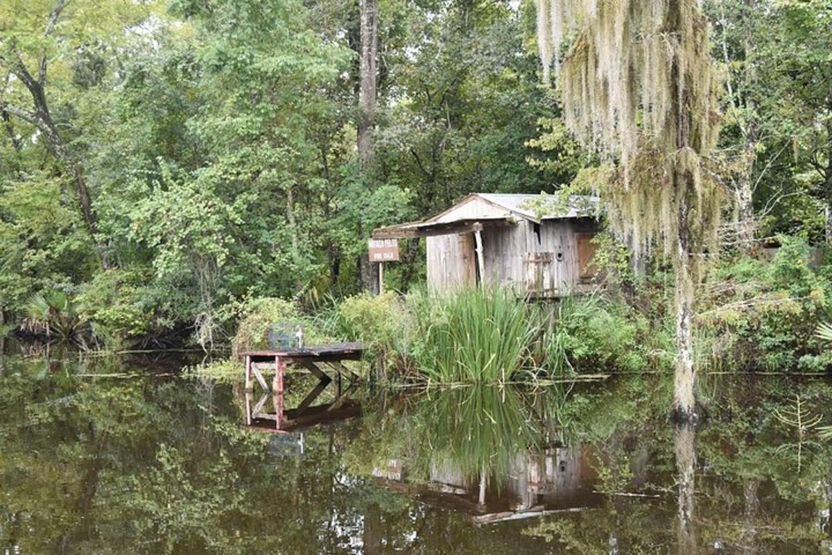 an old shack in the middle of a body of water