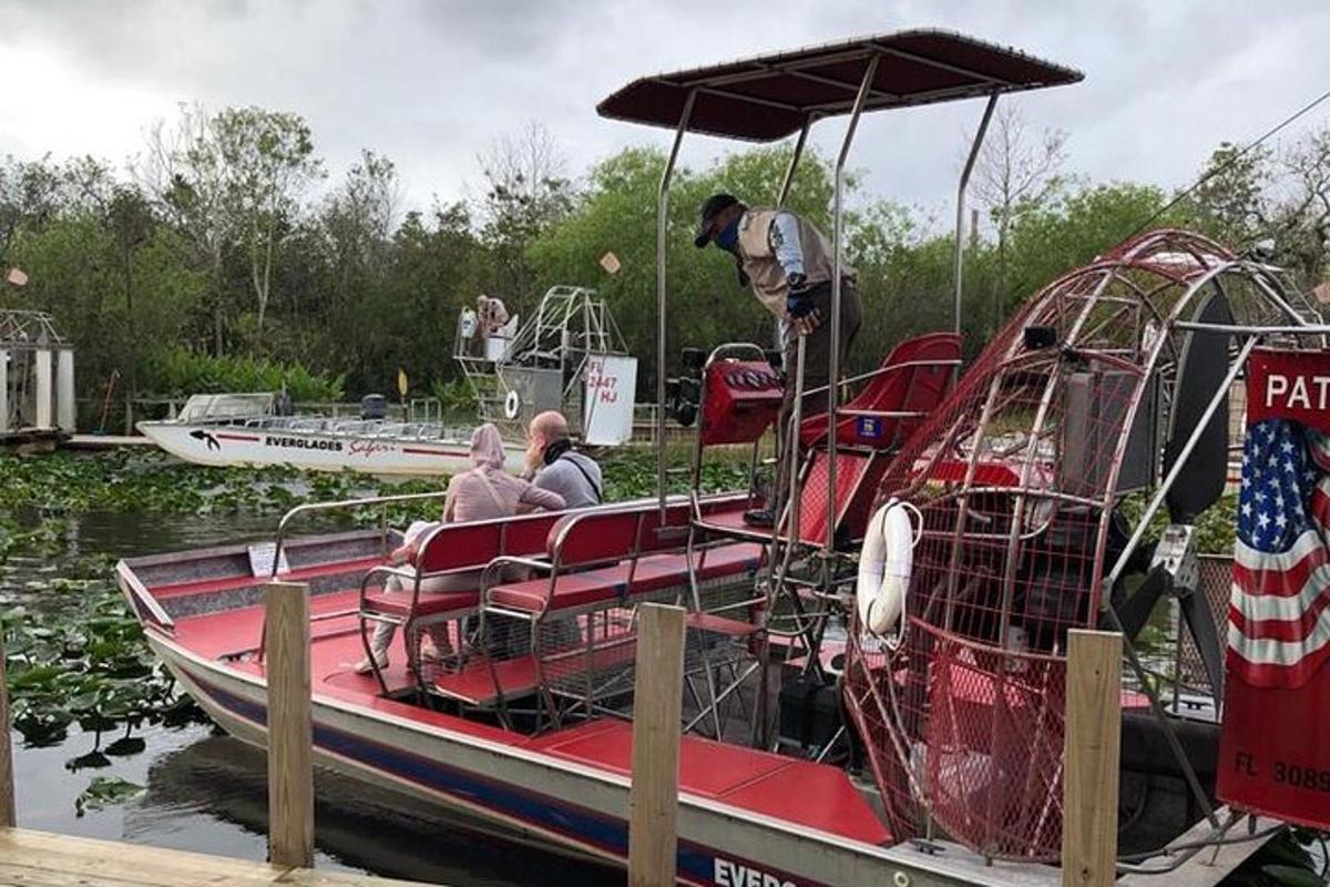 two people sitting on a boat at a dock