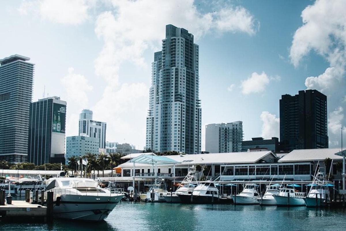 a group of boats docked at a marina in a city