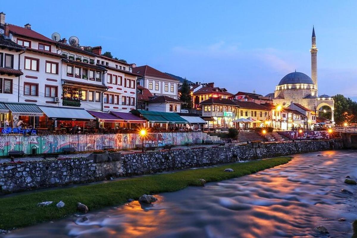 a city with a river and buildings and a mosque