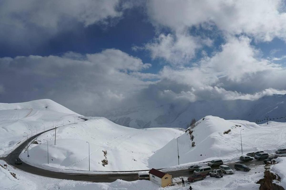 a group of cars parked on a snow covered mountain