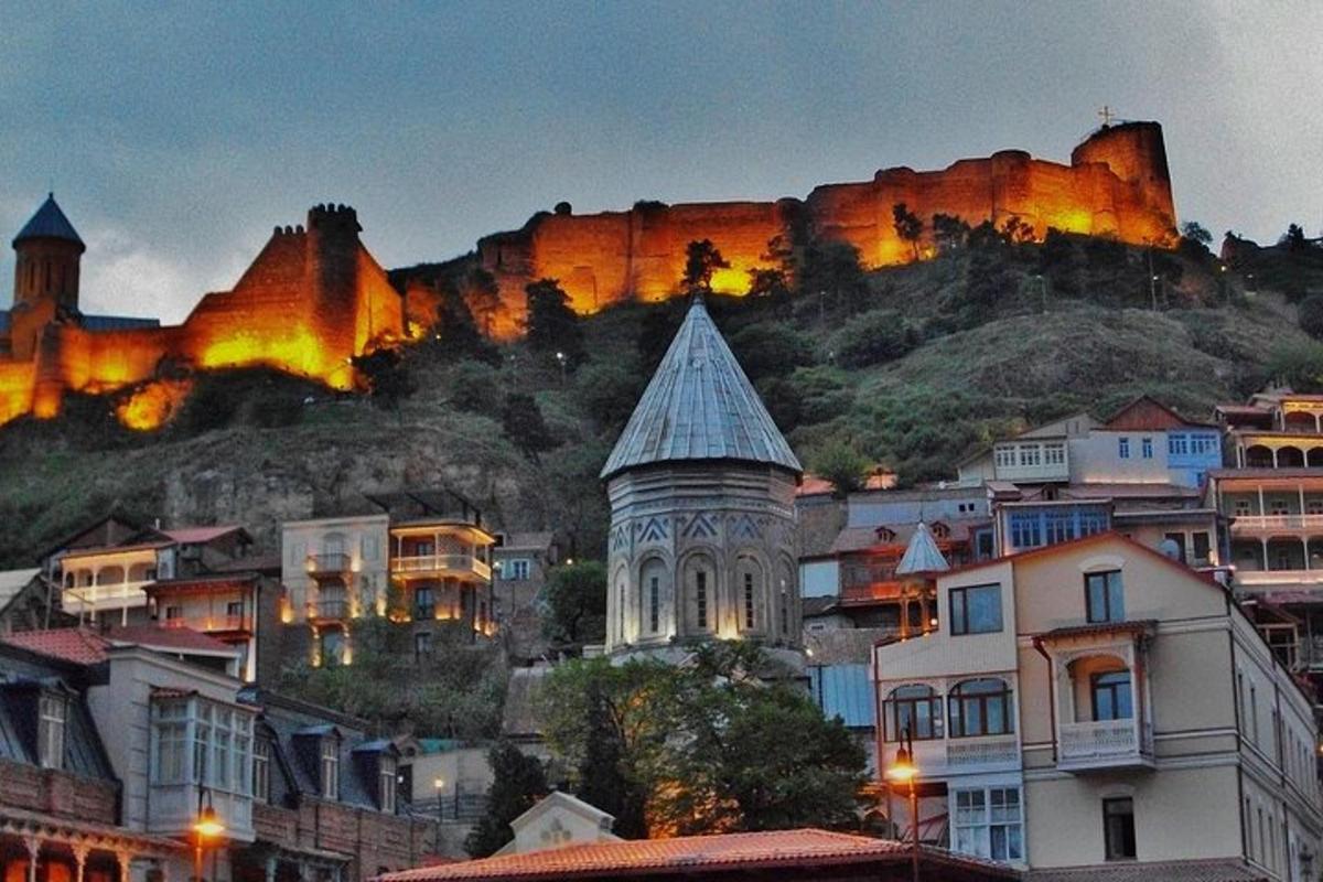 a city with a mountain in the background with buildings
