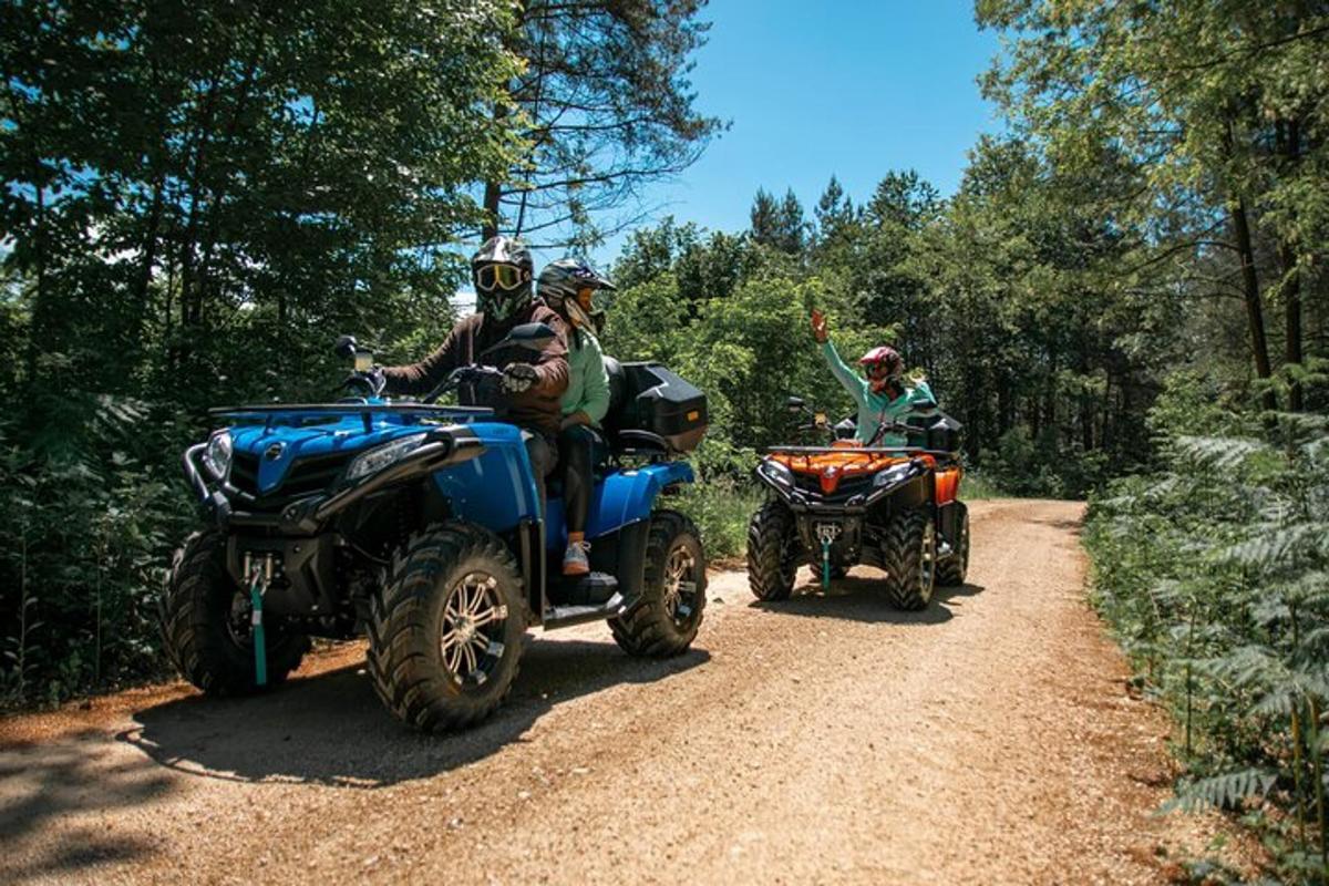 a group of people riding atvs on a dirt road