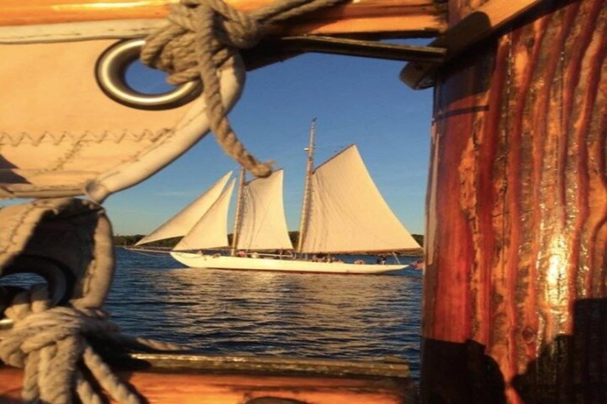 a sail boat on the water with a sail boat