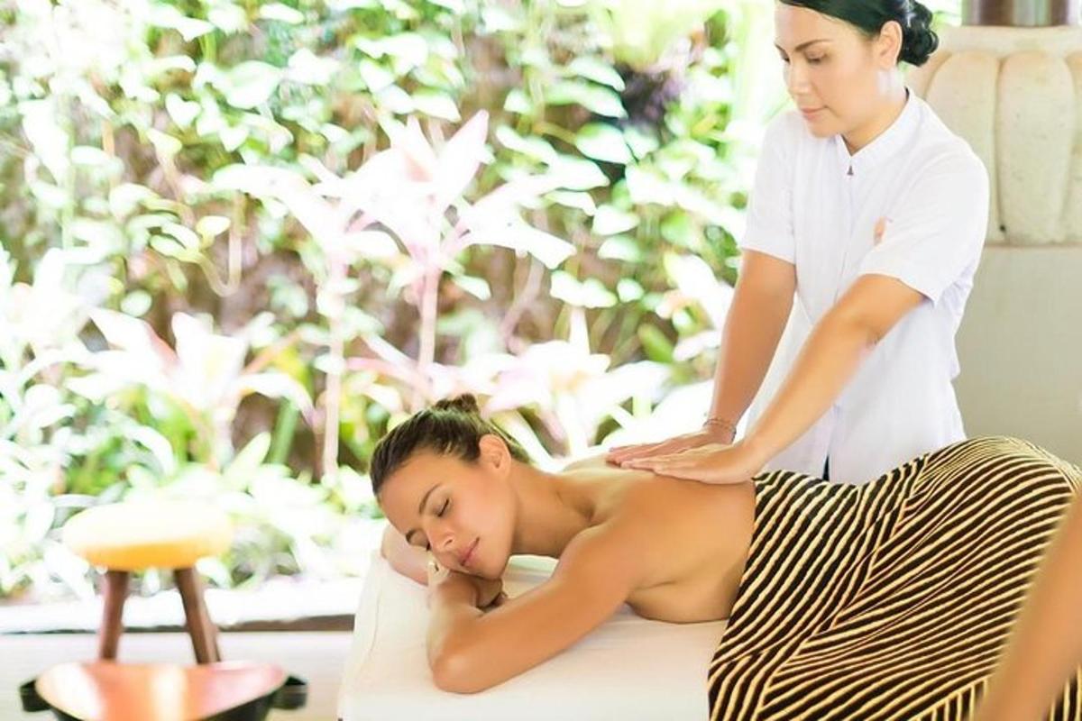 a woman getting a massage from a woman sitting on a table