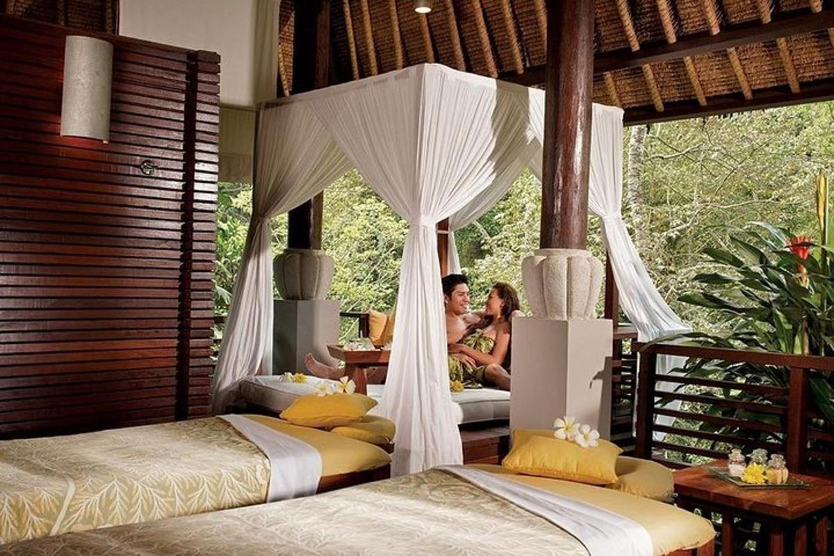 two people sitting in a bedroom with two beds