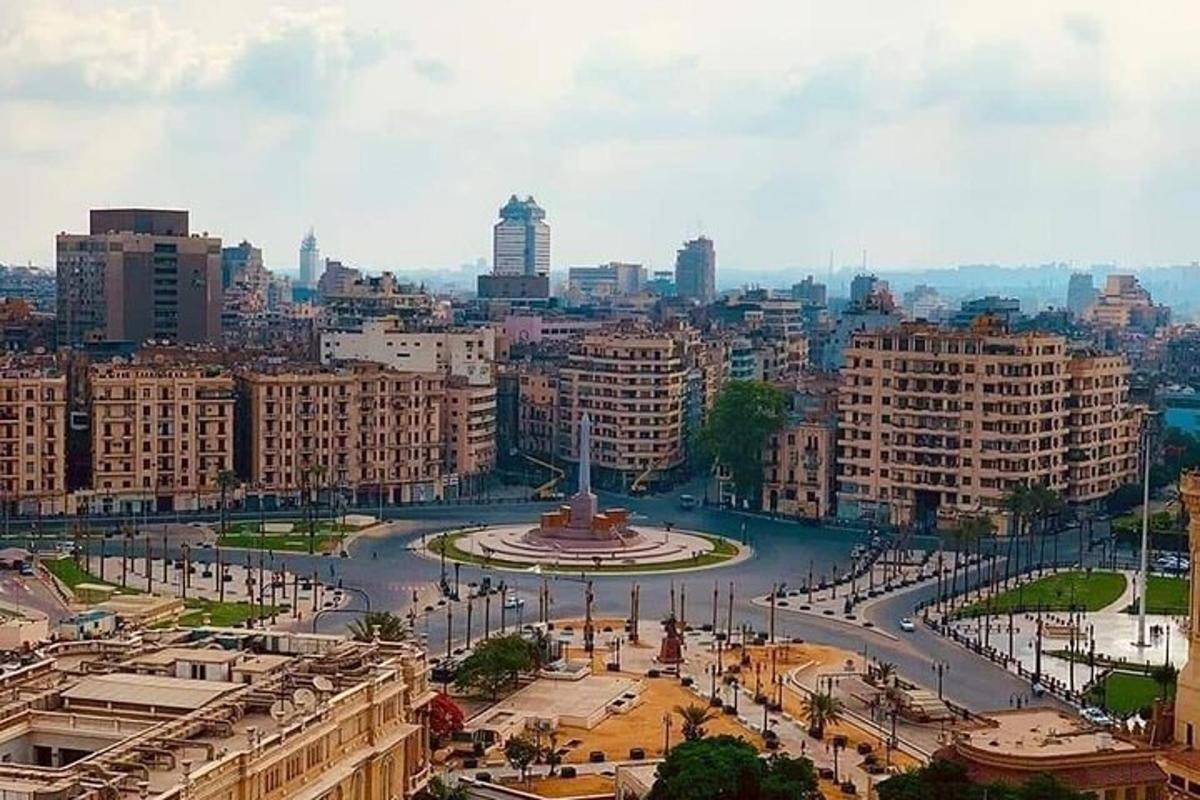 a view of a city with a fountain and buildings