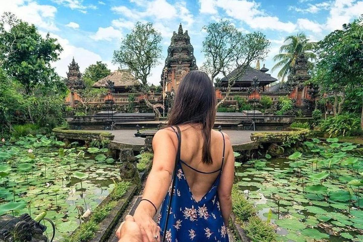 a woman standing in front of a pond of water lilies