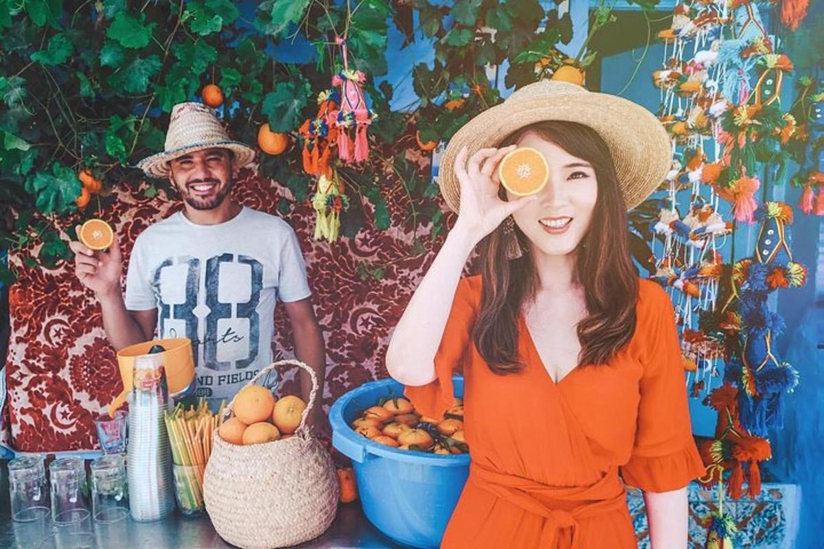 a woman wearing a hat and a man drinking orange juice