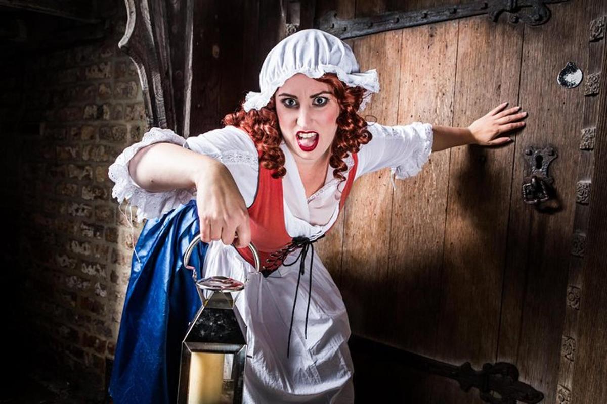 a woman dressed up as a woman holding a lantern