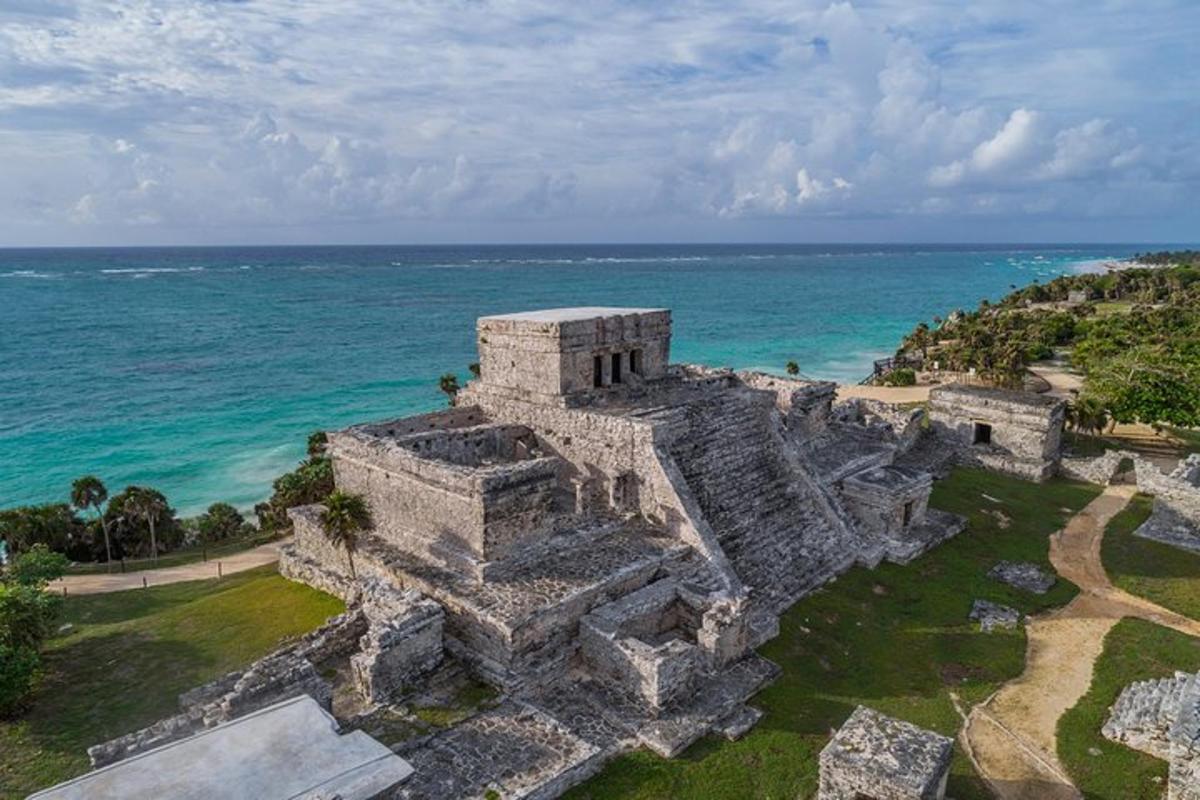 an aerial view of a castle by the ocean