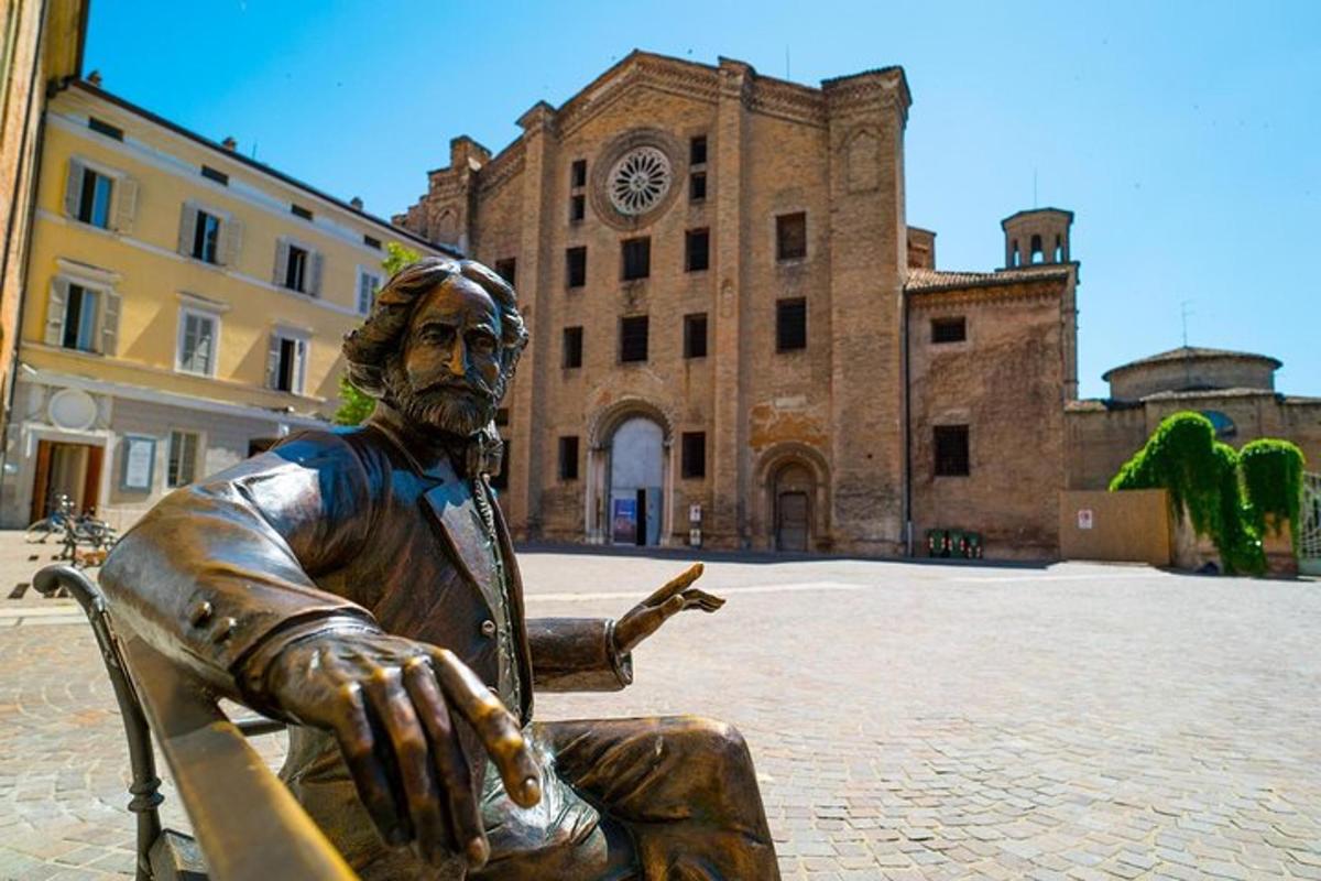 a statue of a man sitting in a chair in front of a building