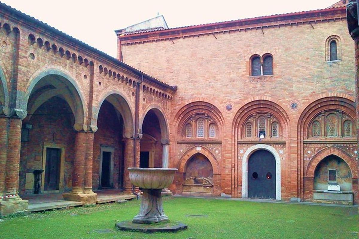 a large brick building with a vase in front of it