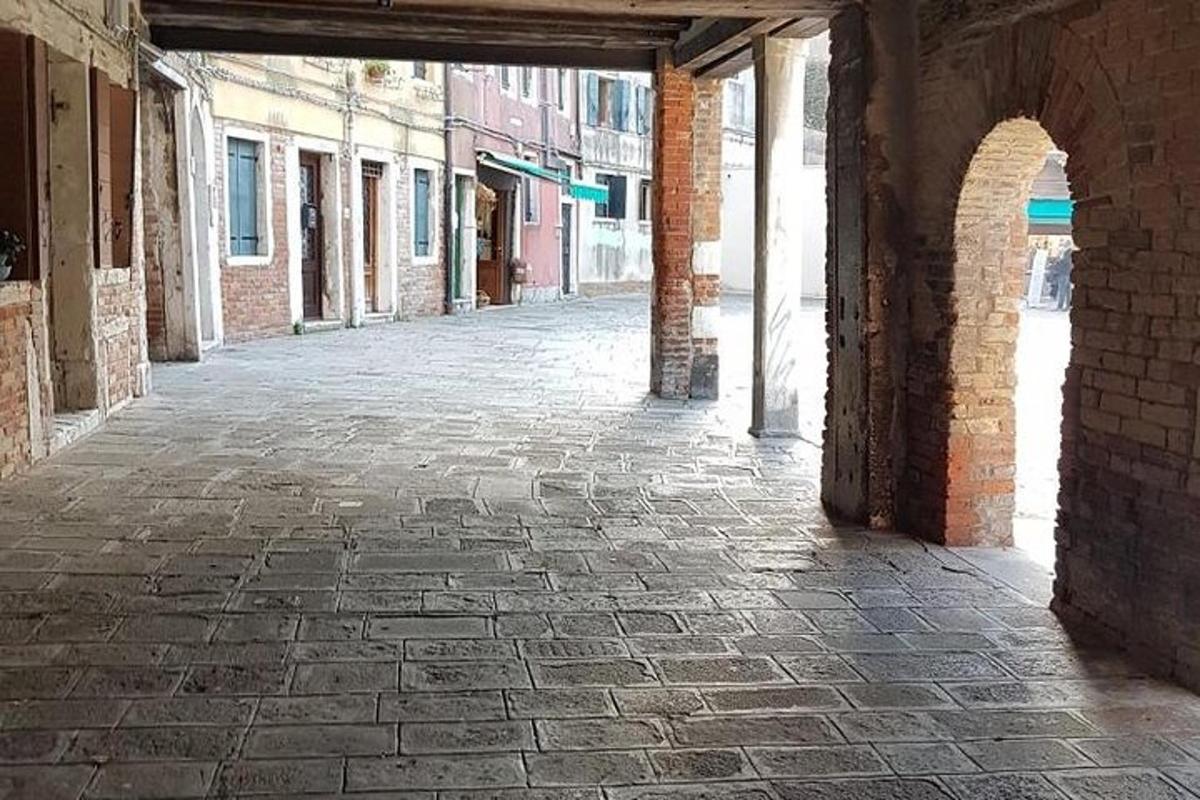 an empty brick alley with an archway in a building