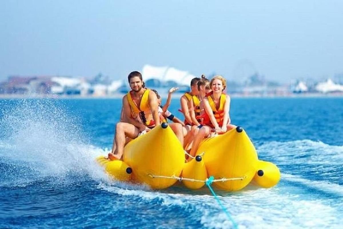 a group of people riding on a banana boat in the water