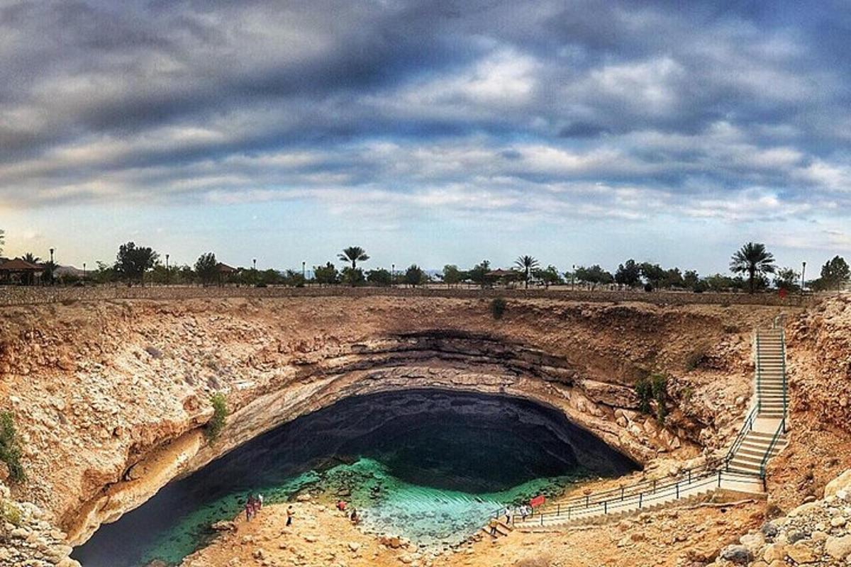 a large hole in the ground with a stairs and water