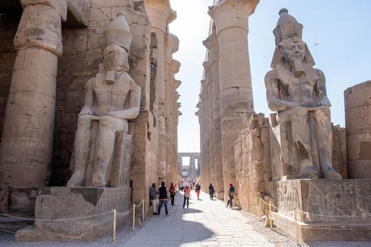a group of people walking around the ruins of a building