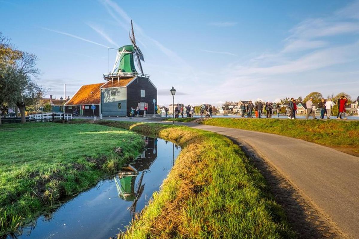 a windmill next to a road next to a river